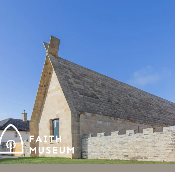 A stone built building with high pointed roof